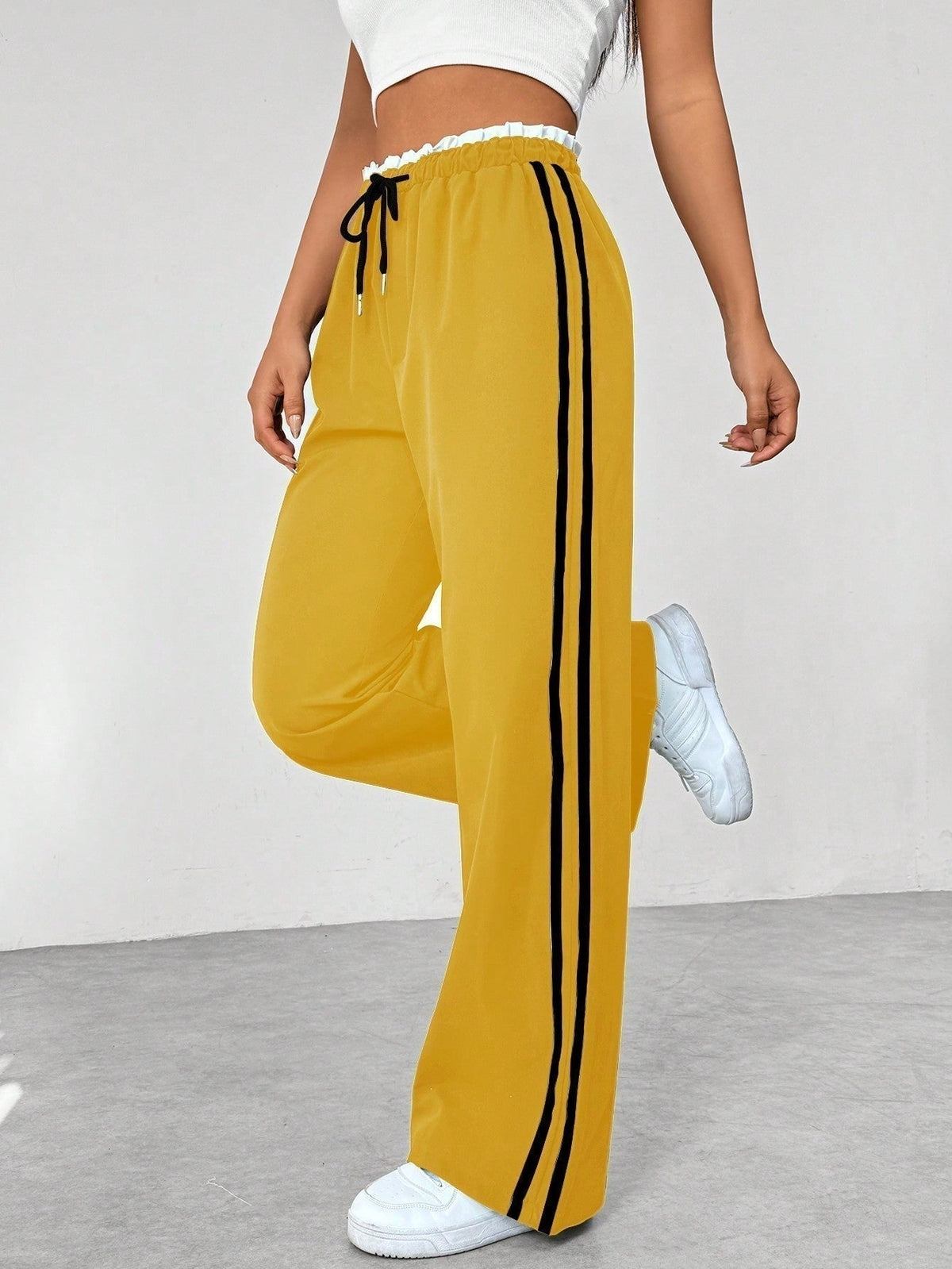 Halima — Pantalón deportivo de pierna ancha con franjas laterales