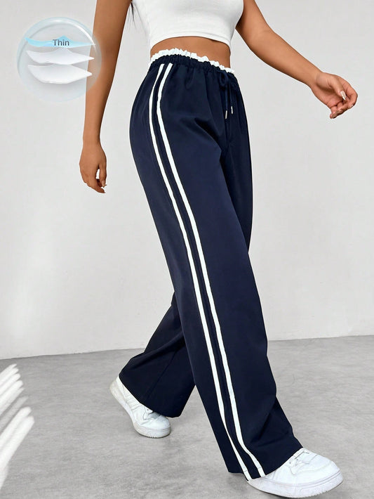 Halima — Pantalón deportivo de pierna ancha con franjas laterales