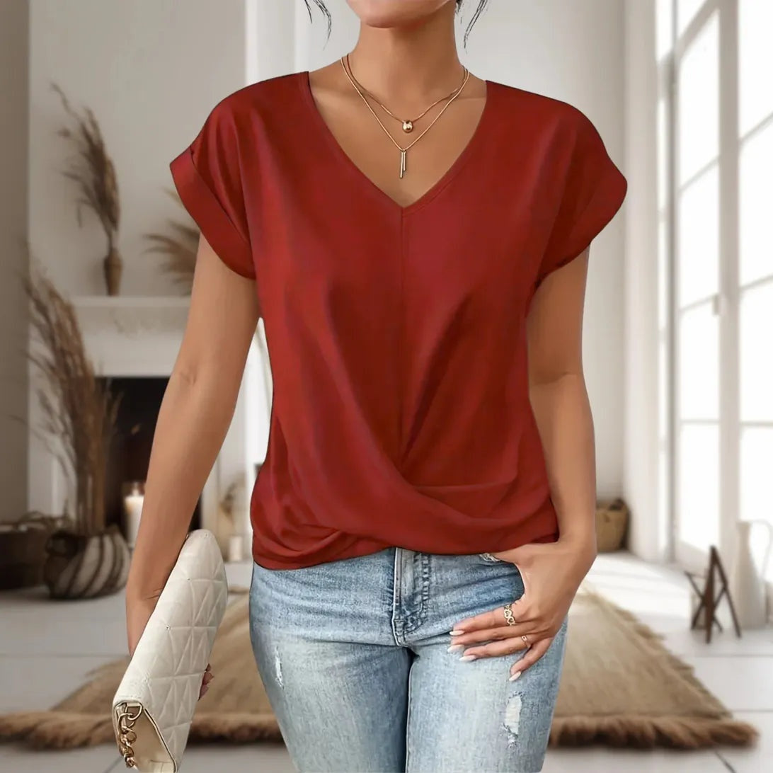 Maia — Blusa de manga corta con cuello en V y dobladillo cruzado